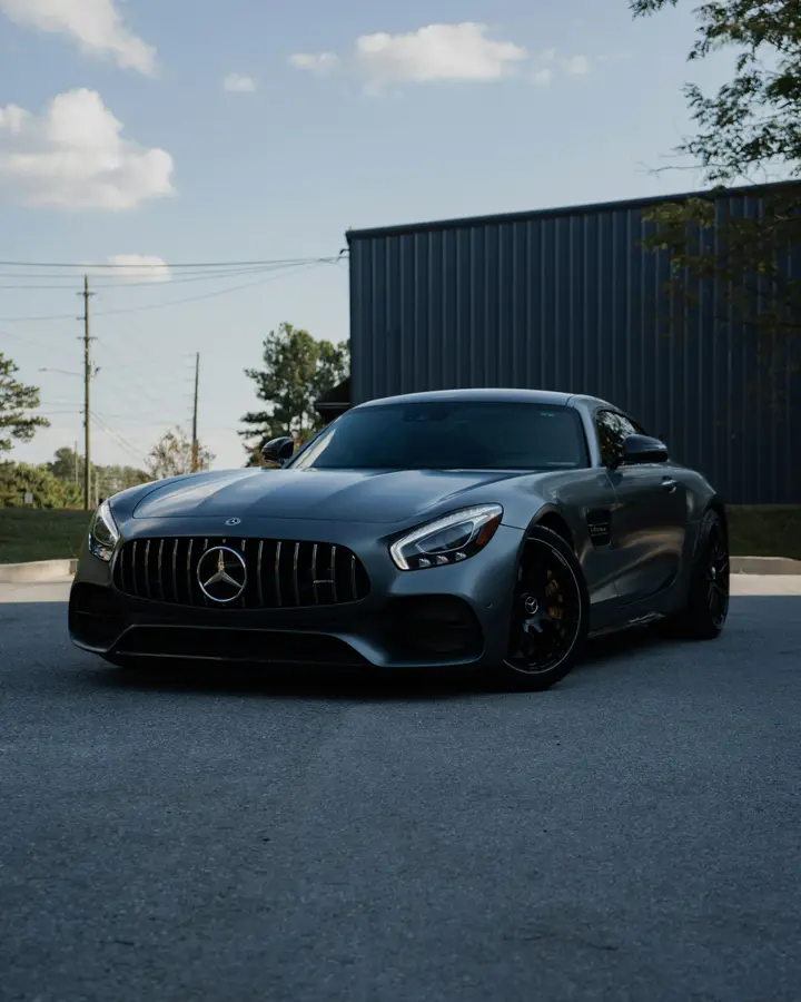 Grey Mercedes-AMG GT coupé parked in the evening light